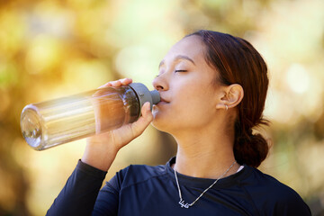 Fitness, nature and woman drinking water after running for hydration, refresh and thirst. Sports, runner and female athlete enjoying a drink after cardio training for a race, marathon or competition.