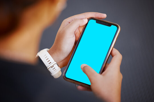 Hands, phone and green screen with mockup for advertising or marketing on display screen from above. Logo, brand or social media with a mobile smartphone in the hand for blue screen product placement