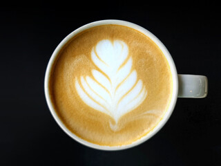 A cup of latte art coffee isolate on dark background