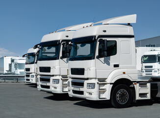 Fleet of white semi trucks in a row	