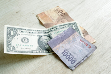 One dollar bills and 15,000 rupiah banknotes. Currency exchange concept
