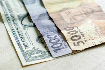 One dollar bills and 15,000 rupiah banknotes. Currency exchange concept
