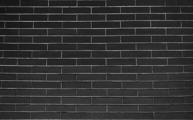 Fototapeta na wymiar Black brick wall background. Black wall background The surface of the brick dark jagged.