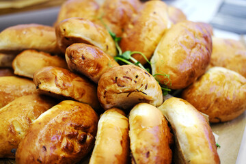 Wooden tray with delicious baked patties. Close up