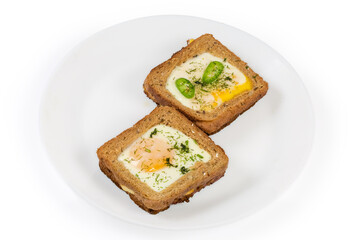 Two open sandwiches with fried egg on a white dish