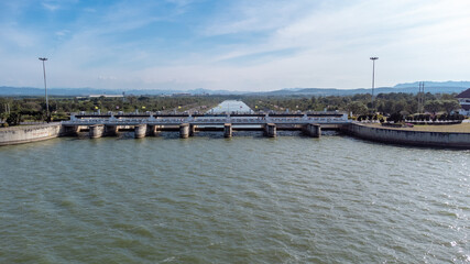 An aerial view over the Pasak Jolasid dam, Lopburi Province, Thailand. Tracking the movement of the floodgates that are releasing water into rural canals in enormous amounts of water.
