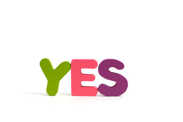 Word yes composed multi colored letters white background.