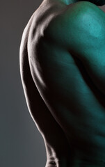 Man, body or muscles on dark studio background and blue light aesthetic, fitness goals or workout progress. Zoom, back skin or bodybuilder model and exercise, training or healthcare wellness strength