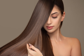 Fashionable brunette woman with straight long shiny hair. beauty and hair care
