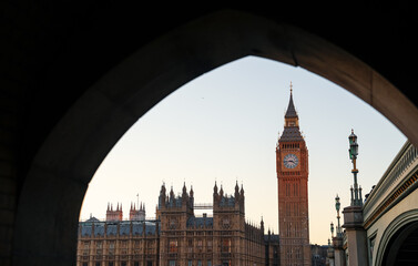Sunset in London, view to iconic landmark Big Ben Clock Tower building after renovation. Landscape from the passage under Westminster Bridge. Travel to England.