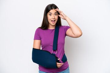 Young Brazilian woman with broken arm and wearing a sling isolated on white background with...