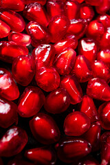 pomegranate seeds on the wooden background