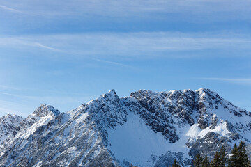 Beautiful panorama of snowy mountains landscape against the blue sky and clouds. Brandnertal, Austria