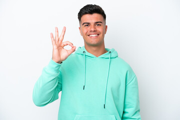 Young caucasian handsome man isolated on white background showing ok sign with fingers