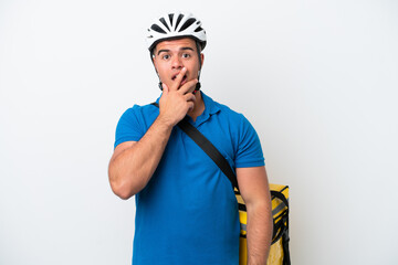 Young caucasian man with thermal backpack isolated on white background surprised and shocked while looking right
