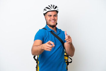 Young caucasian man with thermal backpack isolated on white background pointing to the front and smiling