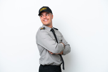 Young caucasian security man isolated on white background with arms crossed and happy