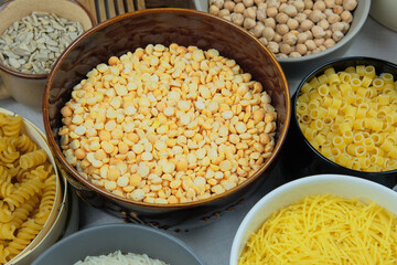 Yellow peas in bowl on a straw background. Vegetarian organic product. Vintage view.
