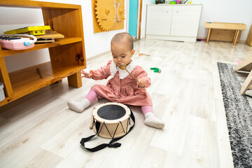 Toddler playing toy drum
