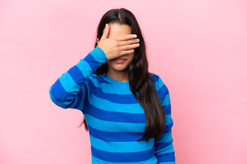 Young Colombian woman isolated on pink background covering eyes by hands. Do not want to see something