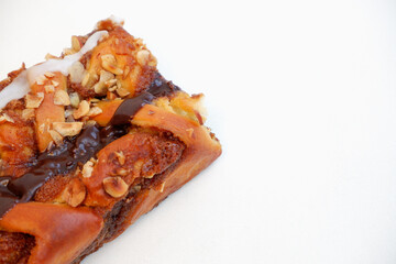 Delicious cake with peanut butter cream layer and chocolate topping. Bakery white background. Selective focus