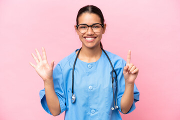 Young nurse Colombian woman isolated on pink background counting six with fingers