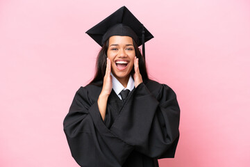 Young university Colombian woman graduate isolated on pink background with surprise and shocked...