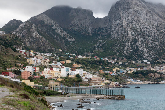 View of the fence separating Ceuta (Spain) and Morocco. Behind the fence we see the village of Belyounech (Morocco), and the Jebel Musa mountain, also known as La Mujer Muerta (the Dead Woman)