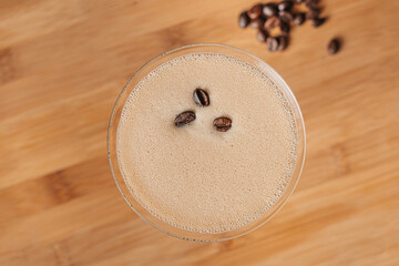 Espresso Martini cocktail garnished with coffee beans, top view