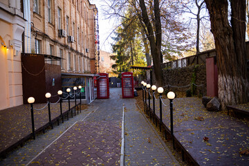 red telephone booths with garlands on the street 