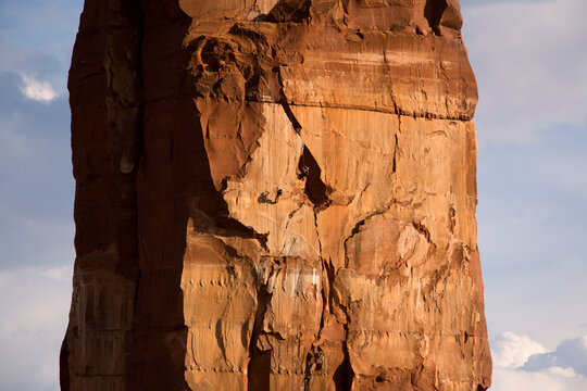 Racers jugging up a tower during an adventure race near Moab, Utah (Low Angle Perspective, Long Distance).