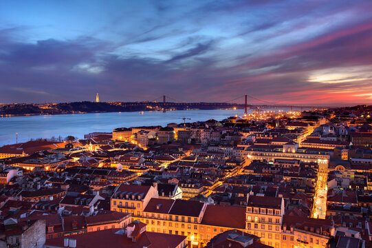 Vista over Lisbon's downtown and two of it's iconic monuments near river Tagus (bridge 25th of April and Holy Christ).