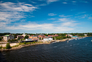 A small coastal town as seen from a high angle on a sunny afternoon.