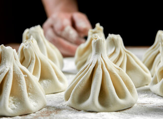 Chef cook making khinkali  on wooden table. Process preparation georgian meal. food concept.