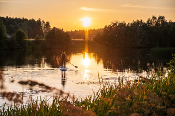 Woman paddling on a Stand up Paddle Board. Nykarleby/Uusikaarlepyy, Finland.