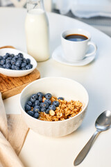 Homemade granola with nuts and fresh blueberries for breakfast. Healthy breakfast. Vegetarian food concept