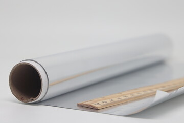 Aluminum food foil and wooden ruler, foil cooking, proper nutrition.