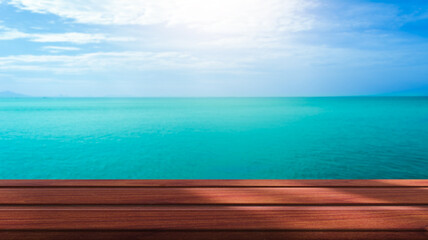 Fototapeta na wymiar Beautiful wooden floor and blue background, sea water and sky.