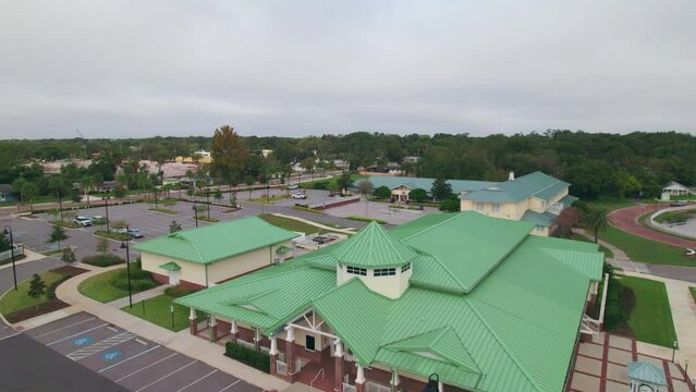 Aerial flyover of the charming and quaint city of Ocoee town hall in Central Florida with nobody outside.  Ocoee is a family oriented town with restaurants, breweries, bars, and shopping.