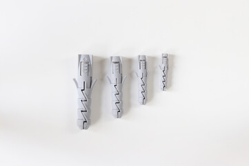Dowels on a light background. Construction dowels of different diameters.