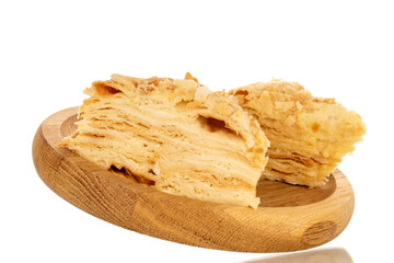 Two pieces of cream cake on a wooden tray, macro, isolated on white background.