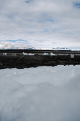 Chunks of ice washed up by the sea lie on the black beach of Breidamerkursandur ( Diamond Beach). They come from the broken icebergs from the glacier lagoon J&ouml;kuls&aacute;rl&oacute;n, which migrate into the sea.