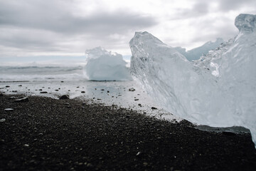 Chunks of ice washed up by the sea lie on the black beach of Breidamerkursandur ( Diamond Beach). They come from the broken icebergs from the glacier lagoon J&ouml;kuls&aacute;rl&oacute;n, which migrate into the sea.
