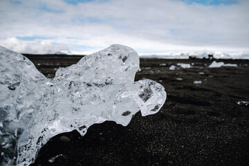 Chunks of ice washed up by the sea lie on the black beach of Breidamerkursandur ( Diamond Beach). They come from the broken icebergs from the glacier lagoon J&ouml;kuls&aacute;rl&oacute;n, which migrate into the sea.