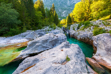 Lepena valley wonderful turquoise Soca river, rocky part popular bathing place in summer - 558897903