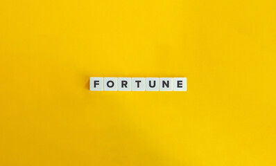 Fortune Word on Block Letter Tiles on Yellow Background. Minimal Aesthetics.