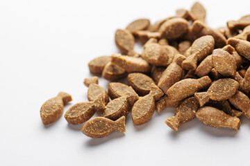 Granules of dry food for dogs on a white background.