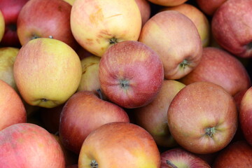 Red apples of the Jonagold variety on the counter of the farmers market. Jonagold apple-tree of American selection with fruits of late winter period. Natural products, seasonal fruits, local food.