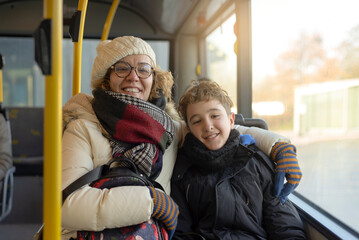 Portrait of a woman and her child seated in a public bus