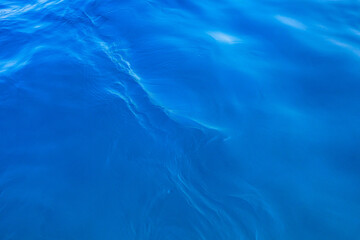 Very nice sea water background or backdrop with selective focus. Small waves of natural water surface texture.